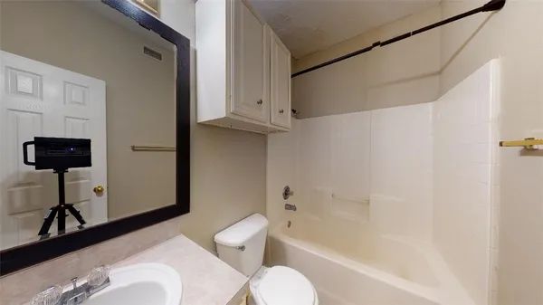 a bathroom with a toilet tub and a shower