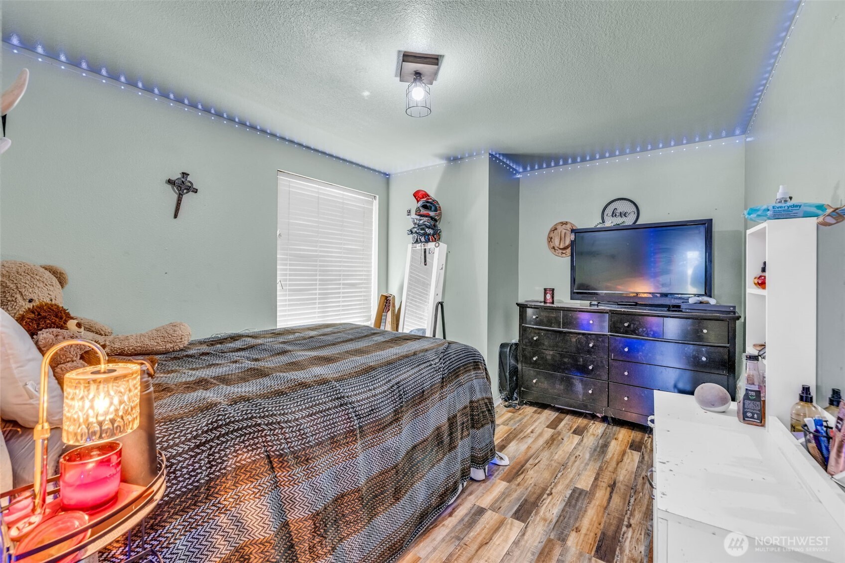 10313 School Land Road Southwest Rochester, WA 98579 - Photo 28 of 40 a bedroom with a bed and a flat screen tv
