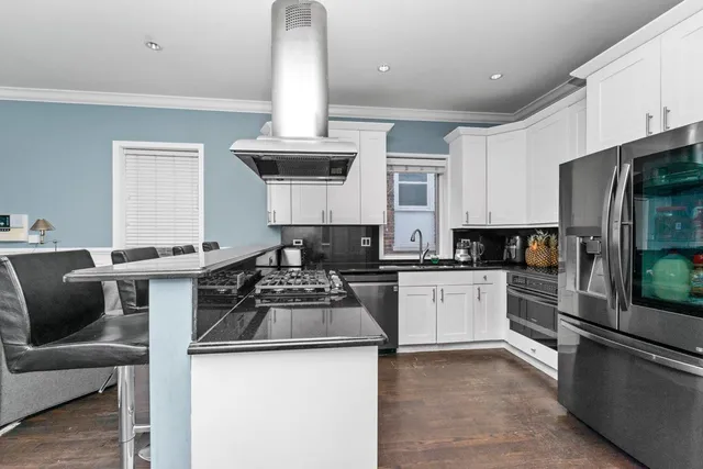 a kitchen with a stove cabinets and a refrigerator