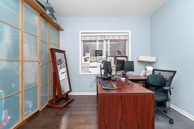 a living room with furniture a flat screen tv and a large window