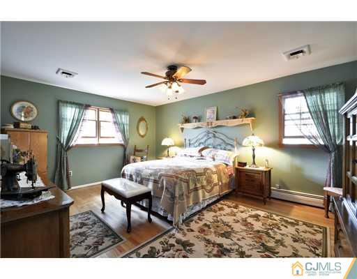 14 Warwick Road Edison, NJ 08820 - Photo 11 of 18 a bedroom with a bed window and wall painting