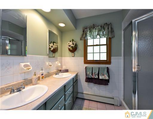 14 Warwick Road Edison, NJ 08820 - Photo 12 of 18 a bathroom with a sink and a mirror
