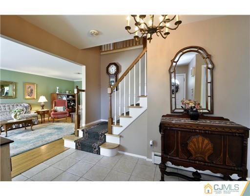 14 Warwick Road Edison, NJ 08820 - Photo 4 of 18 a living room with couches chairs and kitchen view