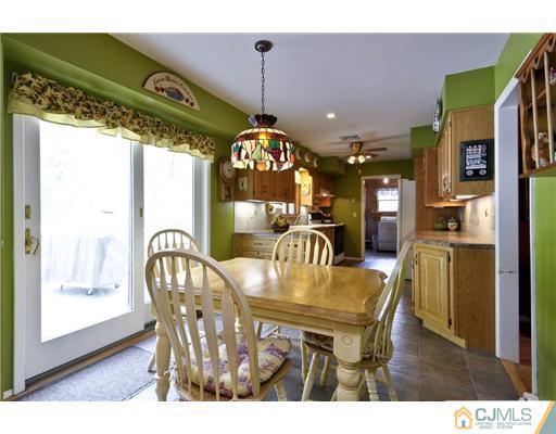 14 Warwick Road Edison, NJ 08820 - Photo 7 of 18 a dining room with furniture a chandelier and wooden floor