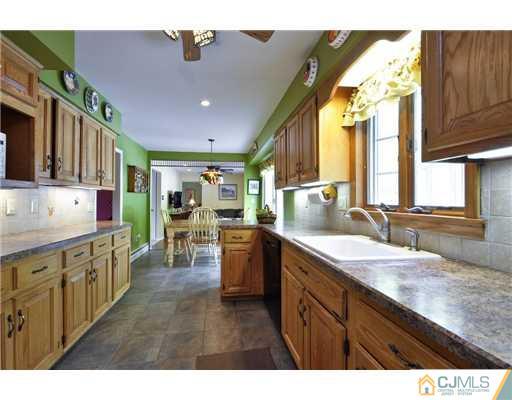 14 Warwick Road Edison, NJ 08820 - Photo 8 of 18 a kitchen with stainless steel appliances granite countertop a sink and cabinets
