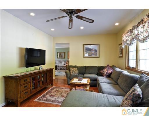 14 Warwick Road Edison, NJ 08820 - Photo 10 of 18 a living room with furniture and a flat screen tv