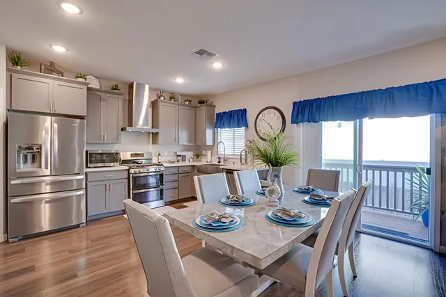 a view of a dining room with furniture kitchen and wooden floor