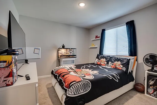 a bedroom with bed and a window