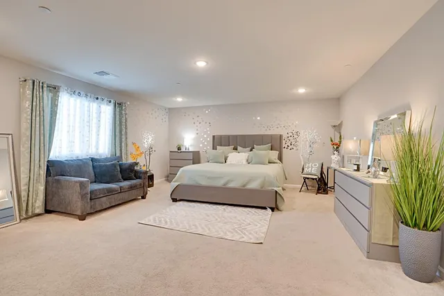 a bedroom with a large bed and a couch