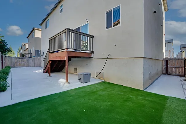 a view of an house with backyard and furniture
