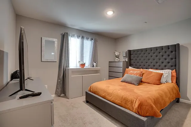 a bedroom with a bed and window