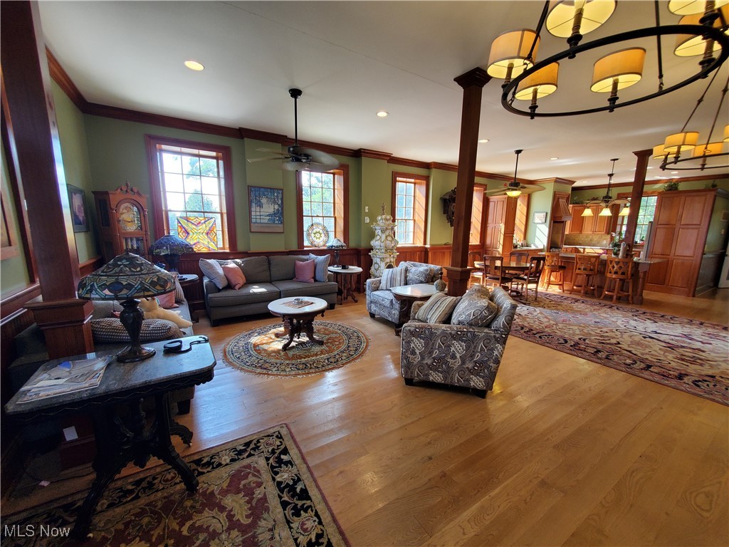 150 Main Street Hayesville, OH 44805 - Photo 7 of 50 Living room with wood finished floors, ceiling fan, recessed lighting, ornamental molding, and ornate columns.