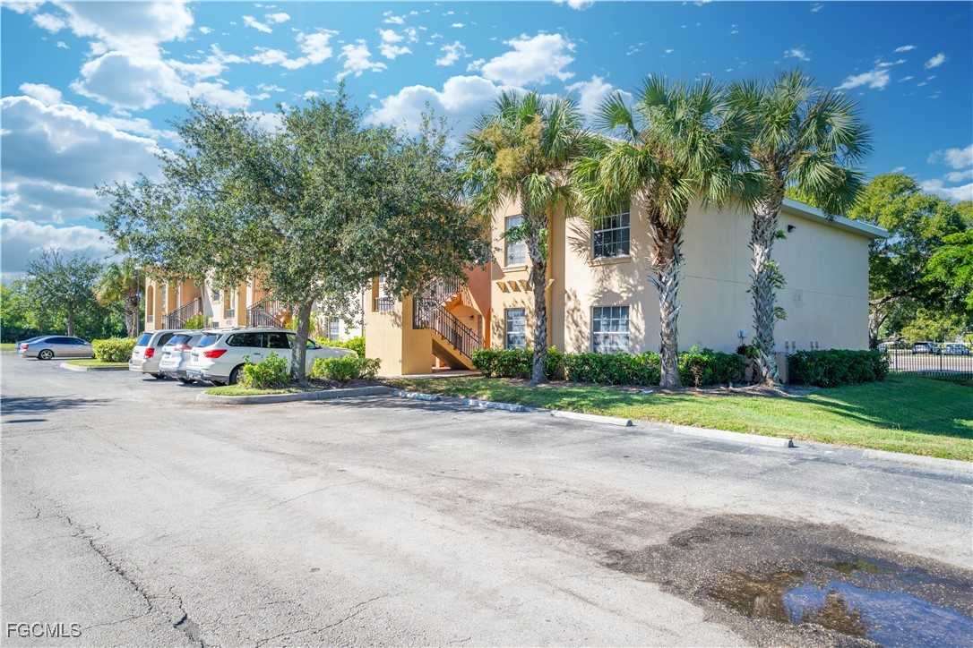 4160 Castilla Circle, Unit 202 Fort Myers, FL 33916 - Photo 21 of 37 a front view of a house with a yard and garage