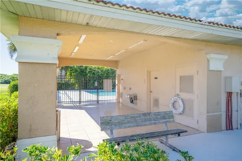 a view of pool with lawn chairs and couches