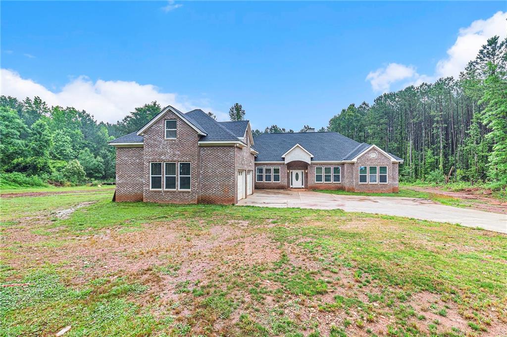 908 Minter Road Griffin, GA 30223 - Photo 1 of 1 a front view of a house with garden
