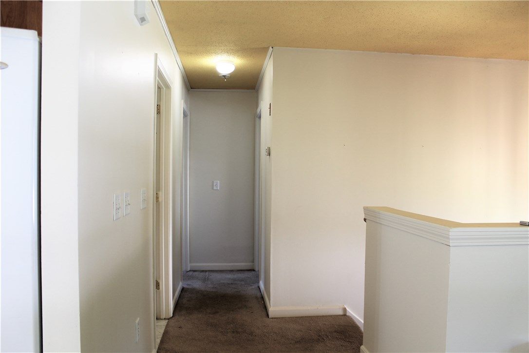 268 Asylum Street Woonsocket, RI 02895 - Photo 7 of 21 1st Floor Hallway leading into bedrooms. Master on left w/ 1/2 bath, and 2nd Bedroom on the right.