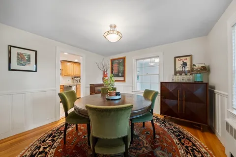 a dining room with furniture and wooden floor