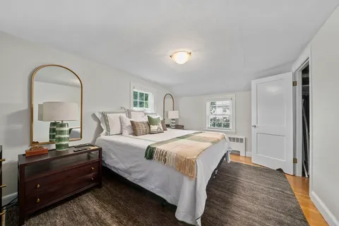 a bedroom with a bed and a television