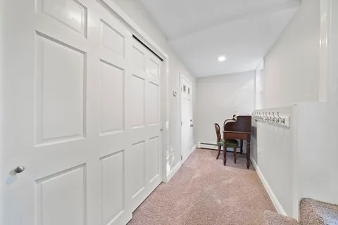 a living room with furniture and a lamp