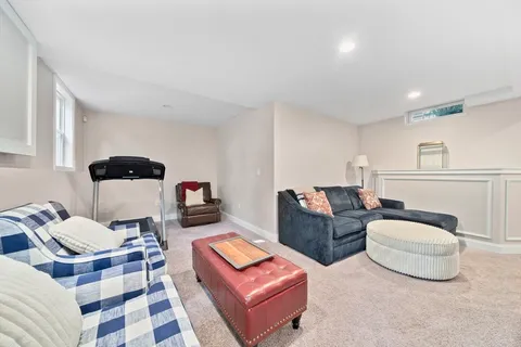 a living room with a bed and a window