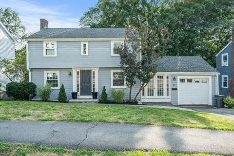 a view of a house with backyard sitting area and a garden