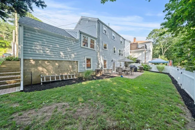 an aerial view of residential houses with outdoor space and trees