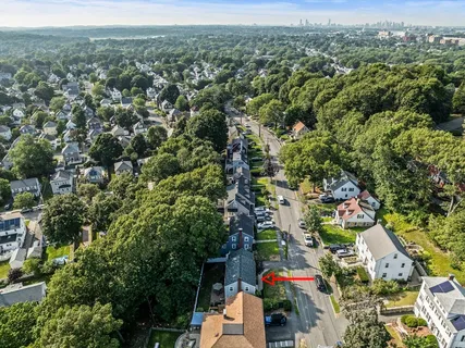 a view of a patio with a table and chairs under an umbrella