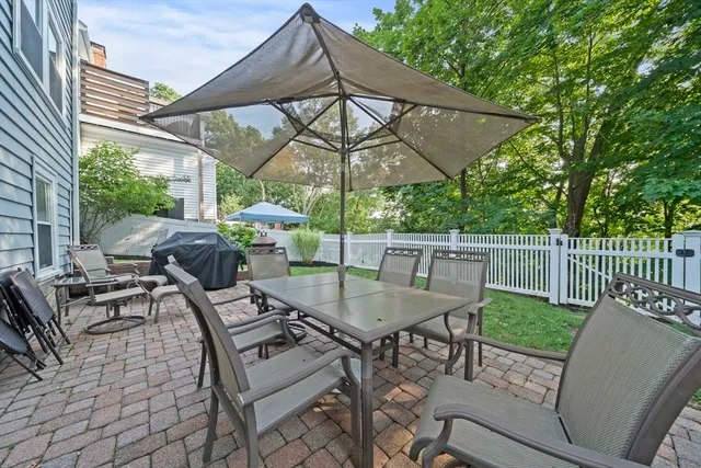 an aerial view of residential houses with outdoor space and trees