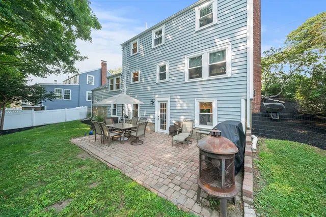 a view of backyard of house with outdoor seating