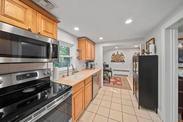 a kitchen with stainless steel appliances granite countertop a sink stove and cabinets