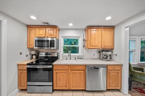 a kitchen with a sink a refrigerator and cabinets