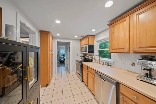a living room with furniture a clock and a fireplace