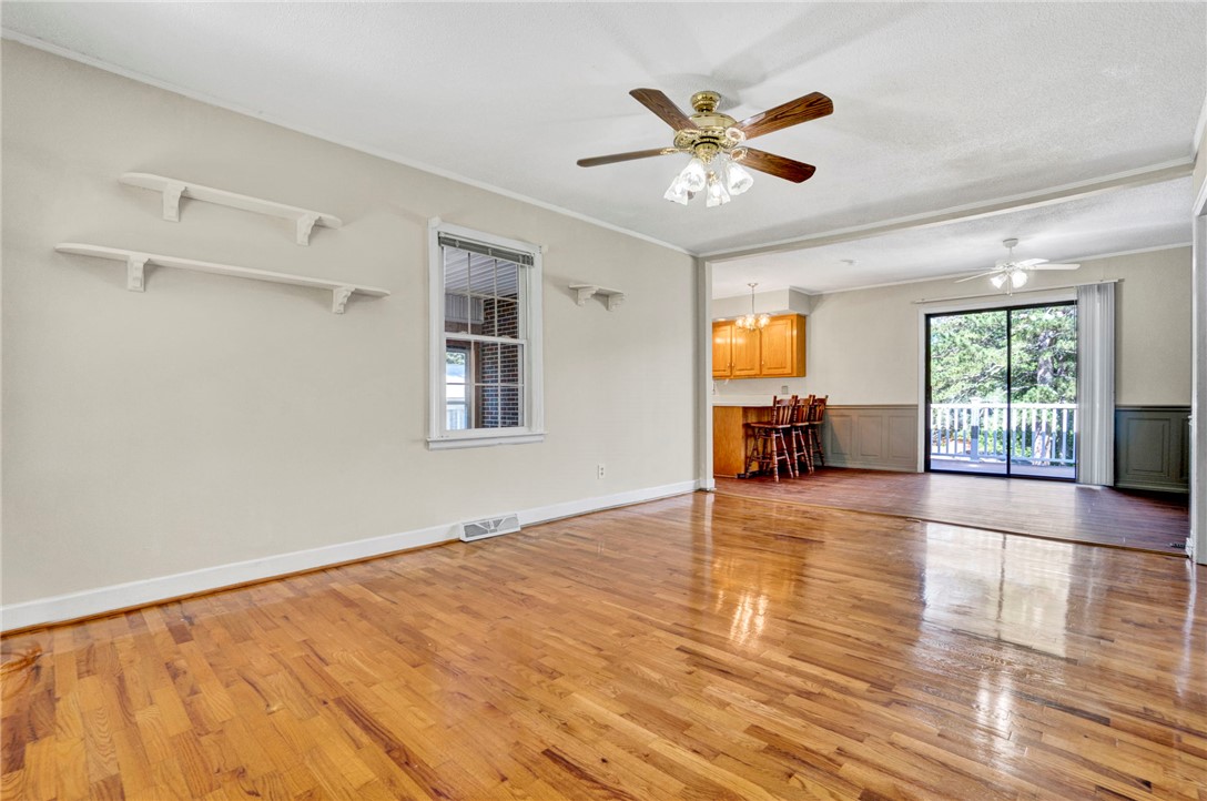 7876 Highway 11 Walhalla, SC 29691 - Photo 12 of 35 Rich hardwood floors flow through this welcoming living area, connecting seamlessly to a bright kitchen and outdoor deck.