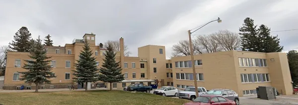 a city street lined with buildings and trees
