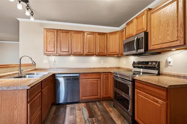 a kitchen with stainless steel appliances granite countertop a sink stove and microwave