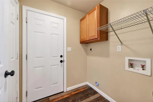 a view of a hallway with wooden floor and entryway