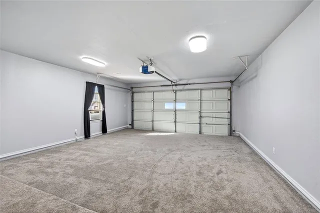 a view of an empty room with a ceiling fan