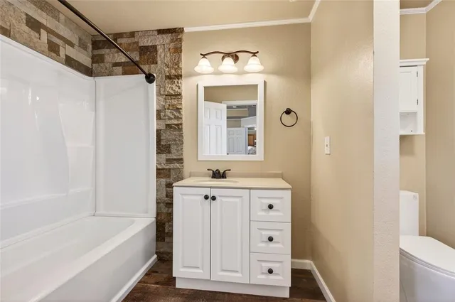 a bathroom with a sink a vanity and a bathtub