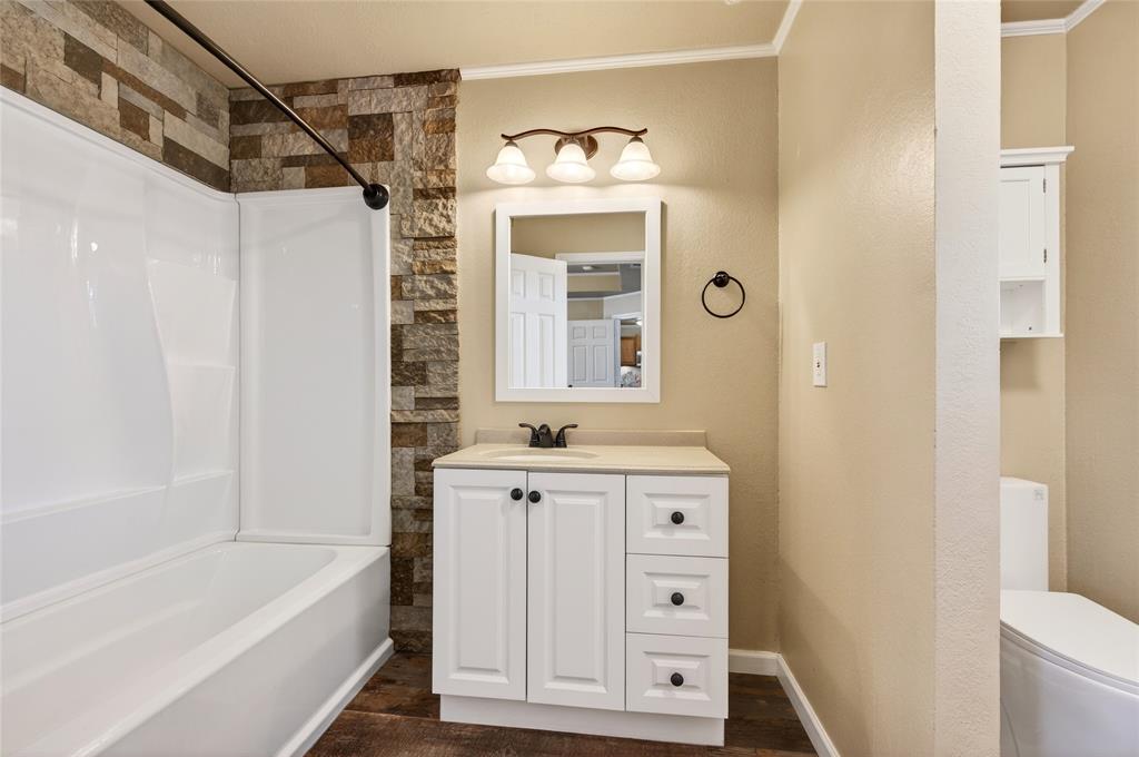 905 Calder Street Howe, TX 75459 - Photo 22 of 35 a bathroom with a sink a vanity and a bathtub