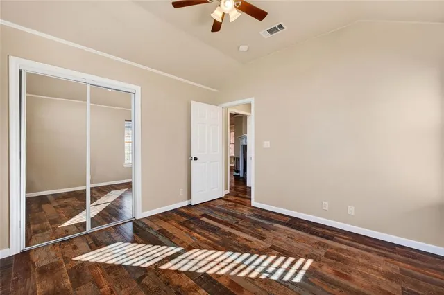 a bedroom with a bed and a chandelier fan