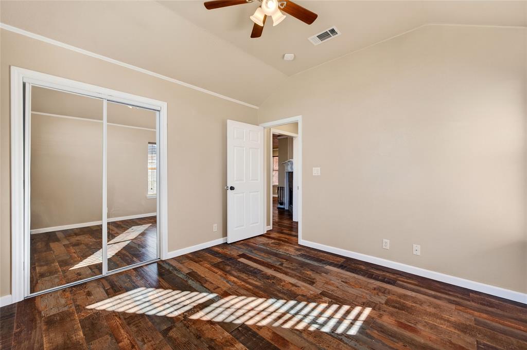905 Calder Street Howe, TX 75459 - Photo 28 of 35 a bedroom with a bed and a chandelier fan