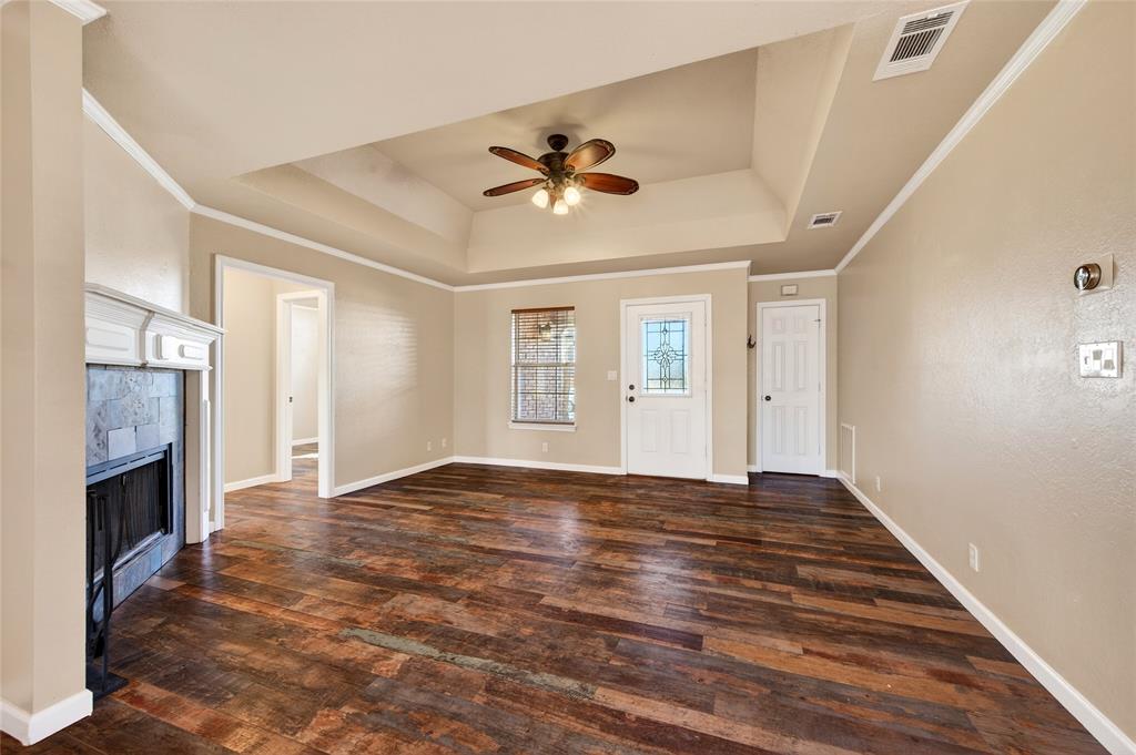 905 Calder Street Howe, TX 75459 - Photo 7 of 35 a view of an empty room with chandelier fan and wooden floor