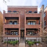 a front view of a building with glass windows and a street