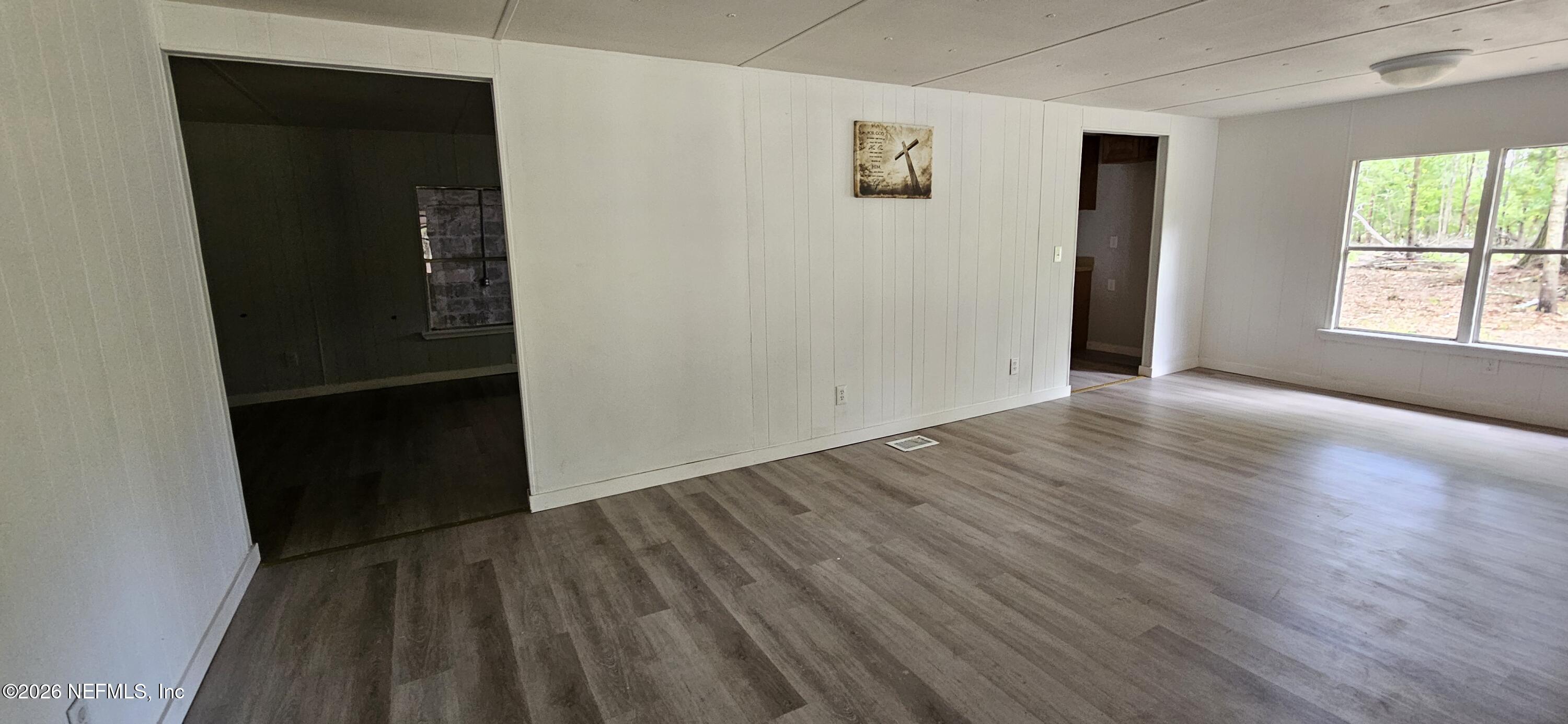 5363 Kilcrease Road Jacksonville, FL 32234 - Photo 7 of 29 an empty room with wooden floor and windows