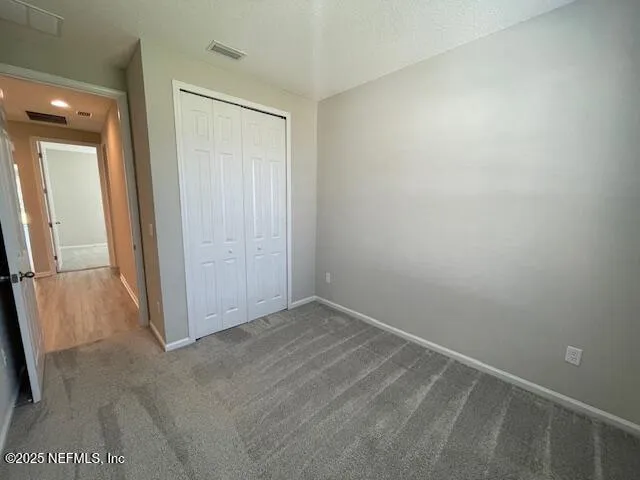 an empty room with an entrance to other room