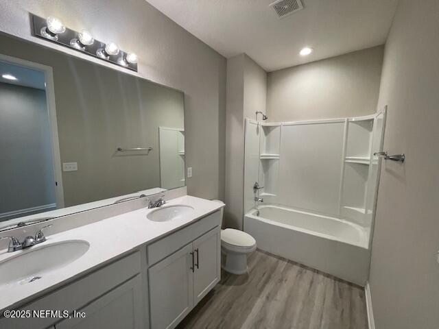 1852 Cogdill Trace Middleburg, FL 32068 - Photo 18 of 25 a bathroom with a double vanity sink a toilet and shower