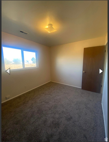 102 East Richelman Lane Wellington, UT 84542 - Photo 15 of 39 Unfurnished room featuring dark carpet and baseboards