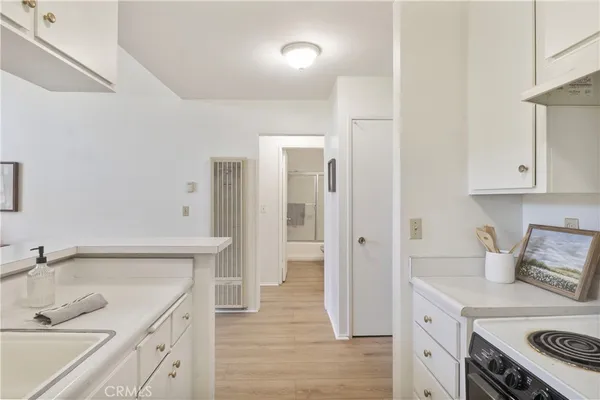 a kitchen with a sink stove and refrigerator