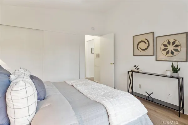 a bedroom with a bed and a painting on the wall