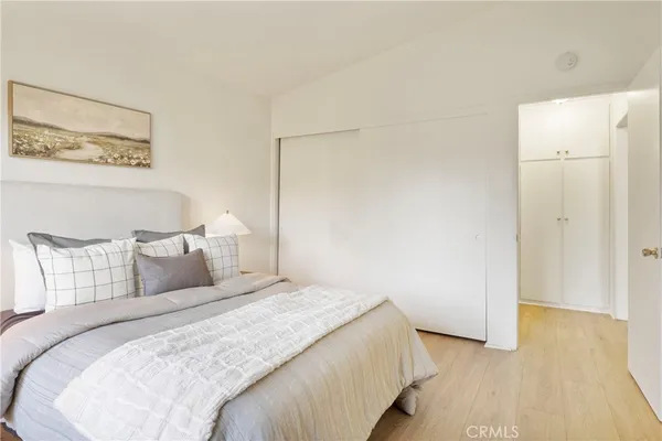 a bedroom with a bed and a night stand